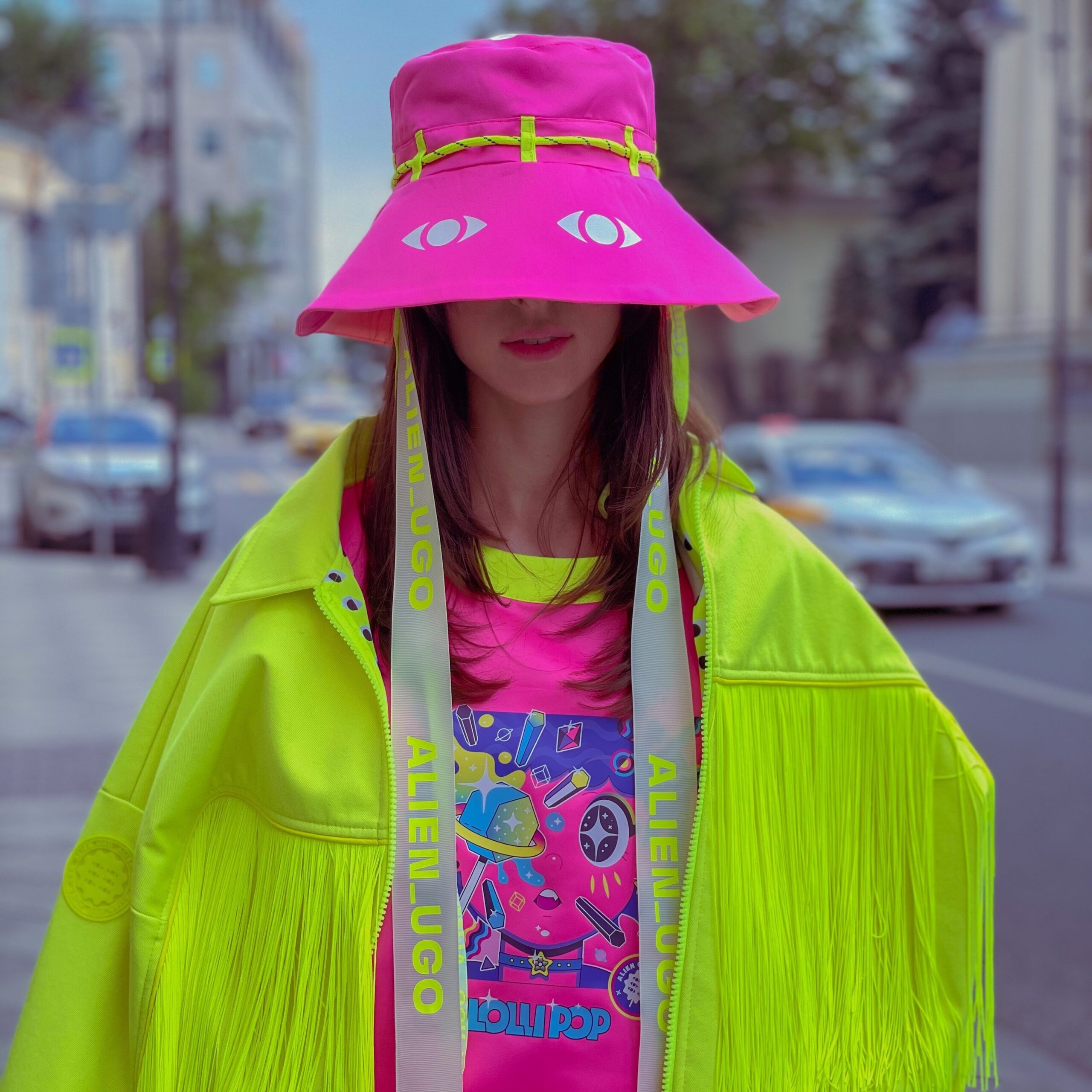 Getting good at sales - girl with neon pink hat and shirt and neon green jacket